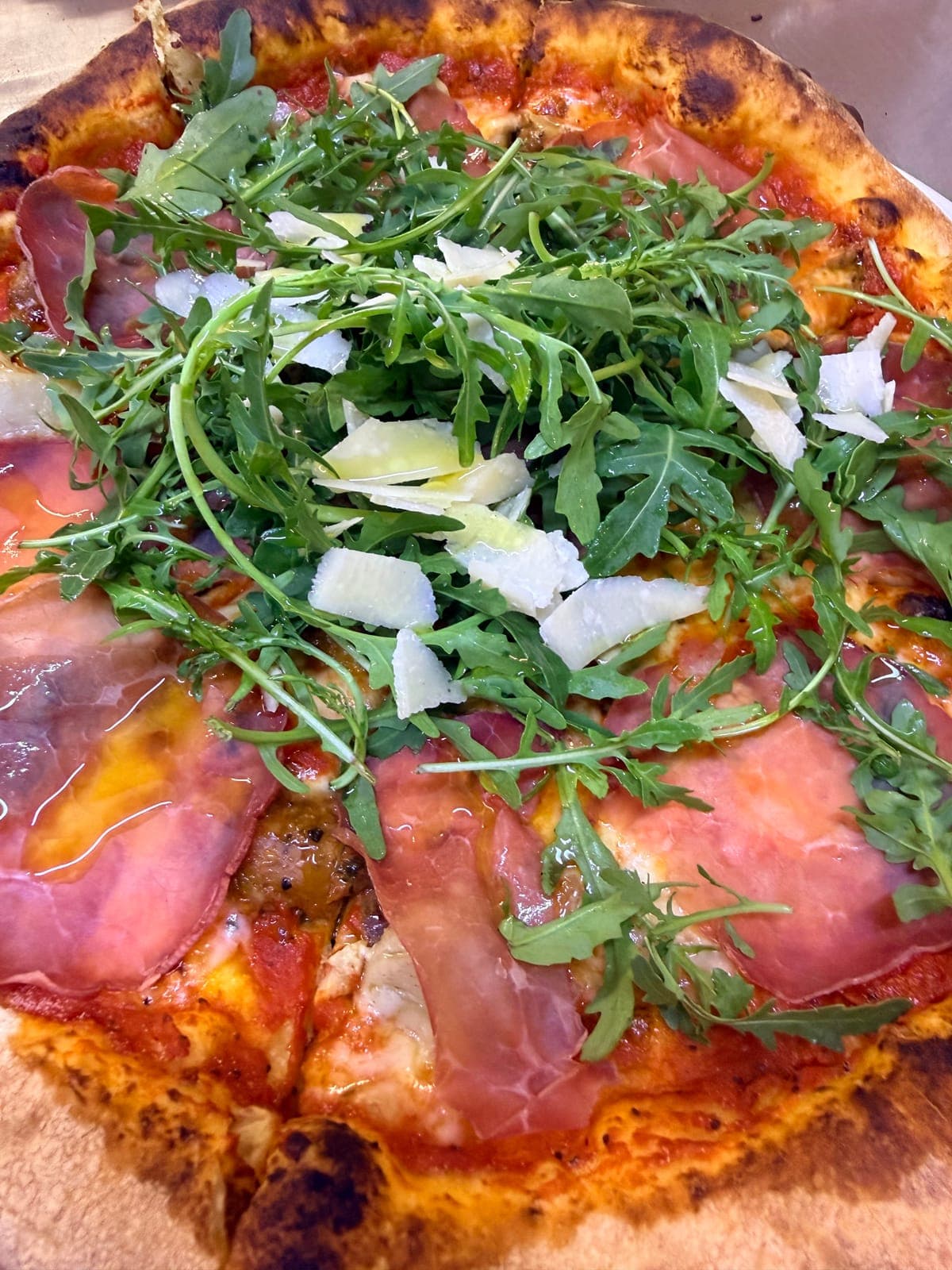Pizza artigianale con prosciutto, rucola e parmigiano